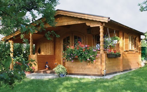 Log cabin with a side room extension, terrace and porch area
